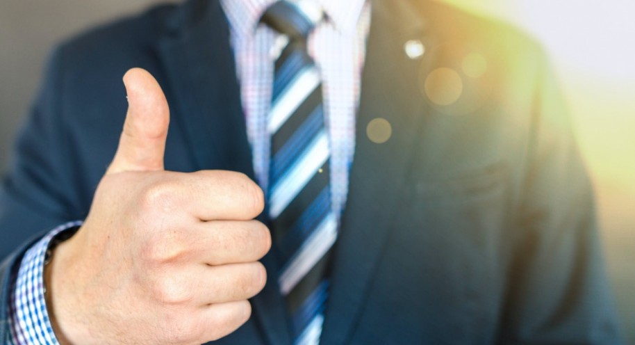 Close-up Photo of Man Wearing Black Suit Jacket Doing Thumbs Up Gesture