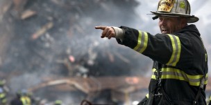 Fire Fighter Wearing Black and Yellow Uniform Pointing for Something