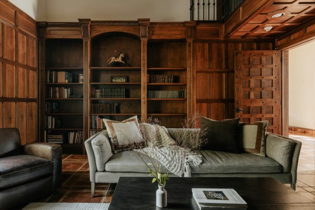 A living room filled with furniture and a book shelf
