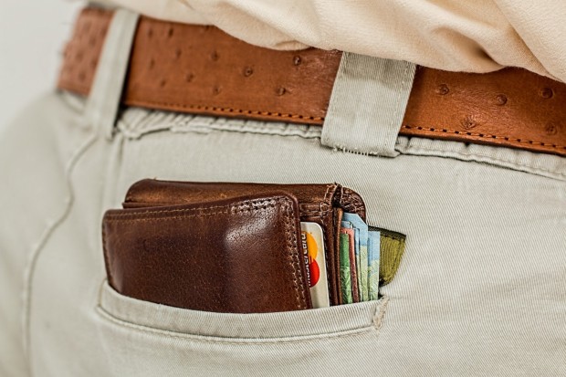 wallet in man's pocket; Caption: Among the most important questions to ask your landlord is which options you have when it comes to paying rent