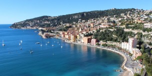 Residential Buildings in Front of Body of Water during Daytime